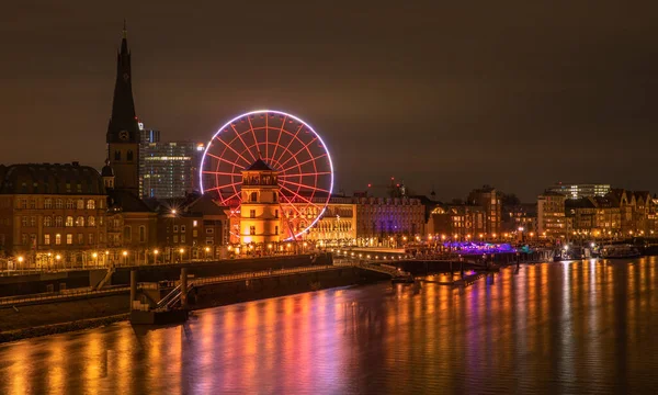 view of city skyline with river, houses, squares and cloudy sky. night Germany Dsseldorf