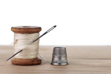 İğneli eski bir iplik makarası. Terzinin çalışma masası. Tekstil ya da kumaş yapımı..