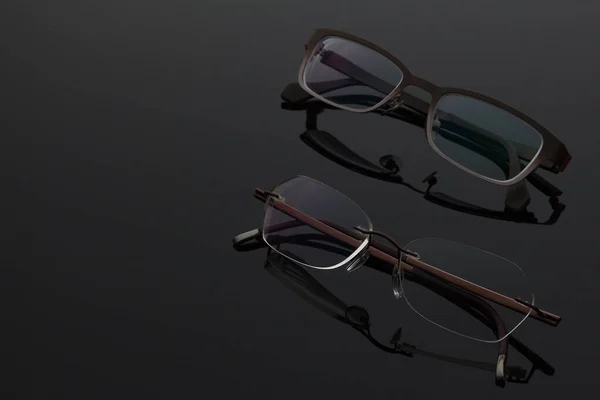 Önden görülen koyu çerçeveli bir gözlük, karanlık bir yüzeye yerleştirilmiş. Arka plan karanlık. Lüks, pahalı eşyalar konsepti. Boşluğu kopyala, seçici odak.