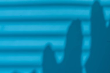 Perdelerin ve yaprakların gölgesi mavi arka planda. Tazelik ve rahatlama kavramı
