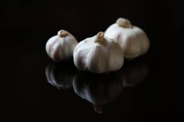 Siyah arka planda taze sarımsak ve yansıma
