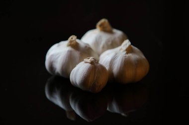 Siyah arka planda taze sarımsak ve yansıma