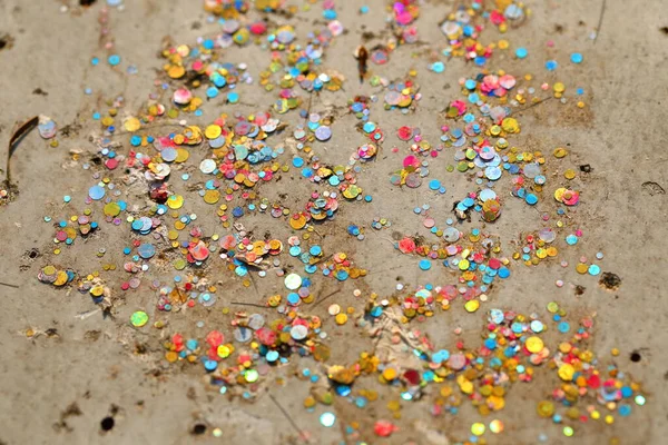 Very small multicolored plastic panels placed on a cement floor