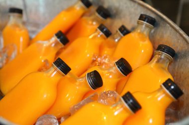 Bottled fresh orange juice, frozen in metal buckets