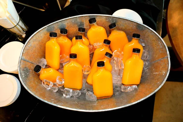 Bottled Fresh Orange Juice Frozen Metal Buckets — Zdjęcie stockowe