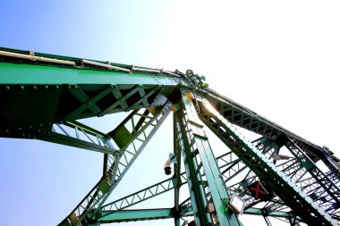A beautiful old green bridge with steel structures in the evening