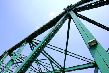A beautiful old green bridge with steel structures