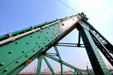 A beautiful old green bridge with steel structures in the evening