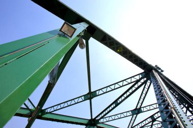 A beautiful old green bridge with steel structures
