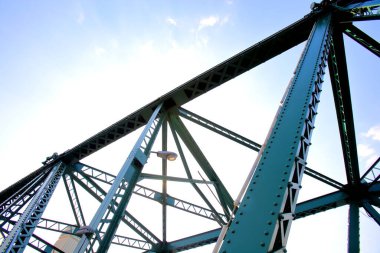 A beautiful old green bridge with steel structures in the evening.