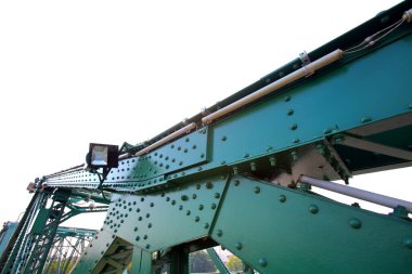 A beautiful old green bridge with steel structures in the evening.