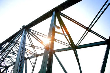 A beautiful old green bridge with steel structures in the evening.