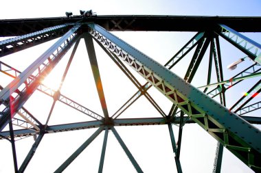 A beautiful old green bridge with steel structures in the evening.
