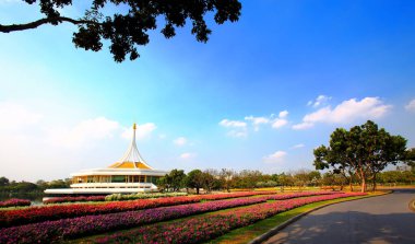 Rajamangkala Hall (The Royal Pavilion) with Colorful flower beds is the land mark in Suan Luang Rama IX Bangkok Thailand.
