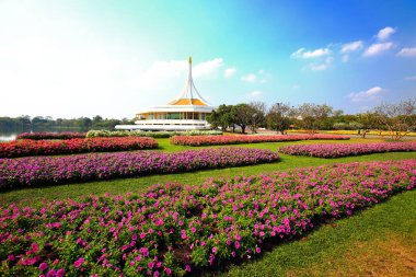 Rajamangkala Hall (The Royal Pavilion) with Colorful flower beds is the land mark in Suan Luang Rama IX Bangkok Thailand.