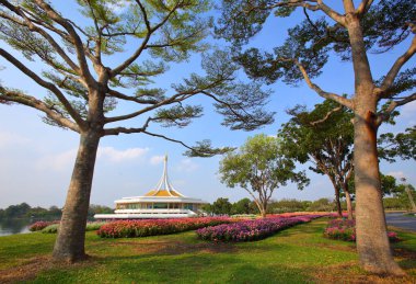 Rajamangkala Hall (The Royal Pavilion) with Colorful flower beds and Terminalia ivorensis trees is the land mark in Suan Luang Rama IX Bangkok Thailand