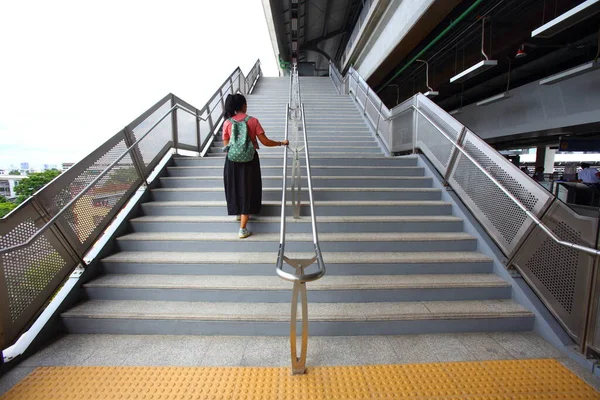 Ladies walking on the sky train stairs, high angle view