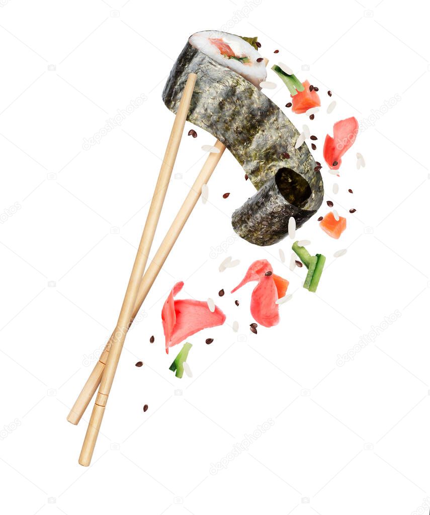 Unwrapped sushi roll sandwiched between chopsticks with ingredients and ginger close-up