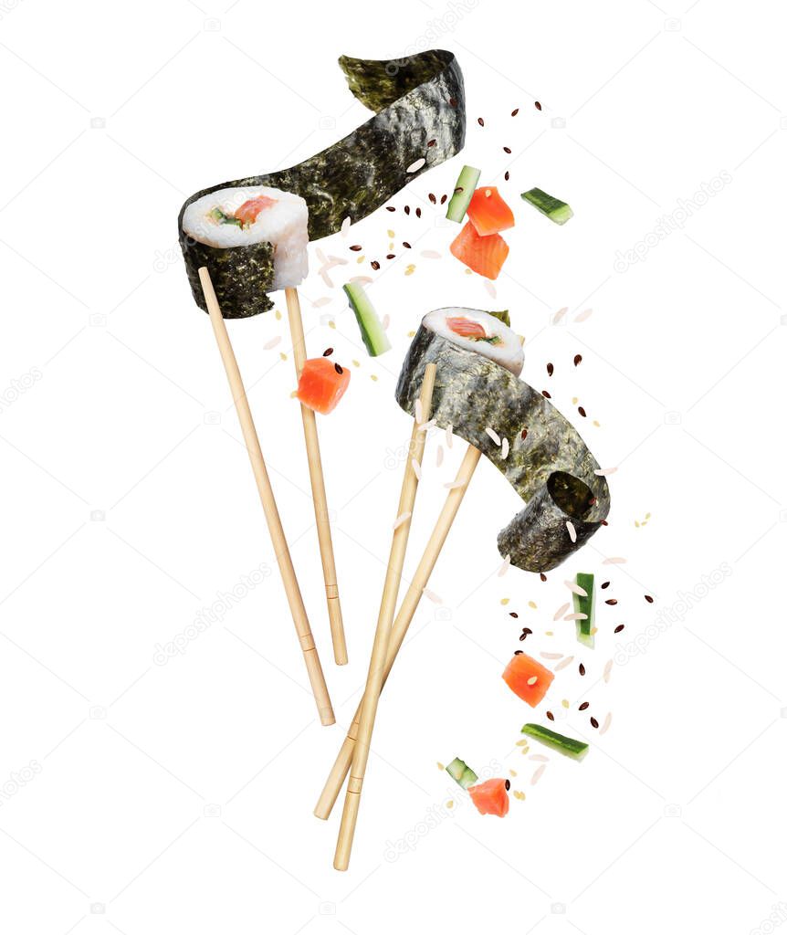 Two unwrapped sushi rolls sandwiched between chopsticks with ingredients close-up
