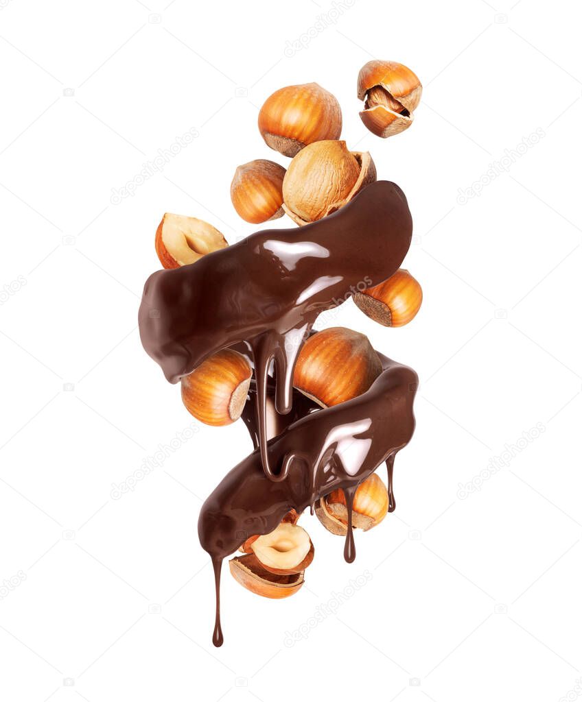 Melted chocolate with dripping drops in a swirling shape with hazelnuts
