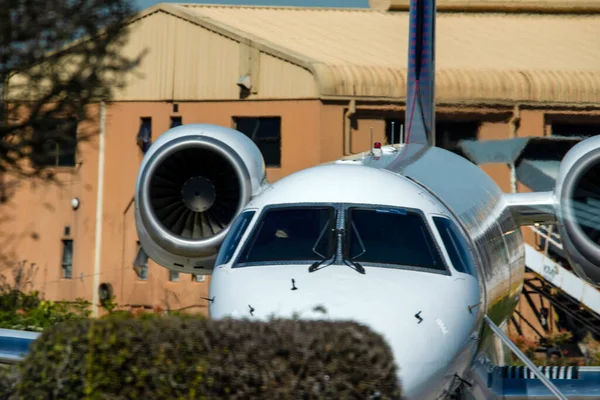 Jet aircraft parked in the parking area of the airport in South Africa being boarded by passengers and preparing to take off. It is an ideal aircraft for medium and long trips reaching high speeds.