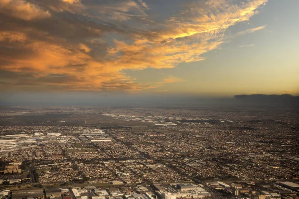 Nice aerial photo of Cape Town (South Africa) in the south of the African continent with the reddish sky at sunset, the photo is taken from an airplane when it is landing at the airport.