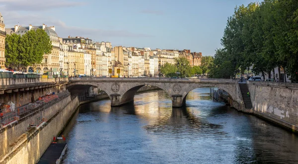 The famous and beautiful small bridge over the Seine river in Paris, this is a beautiful bridge of the Parisian city. This French bridge is very busy in Paris. Concept bridges in Paris.