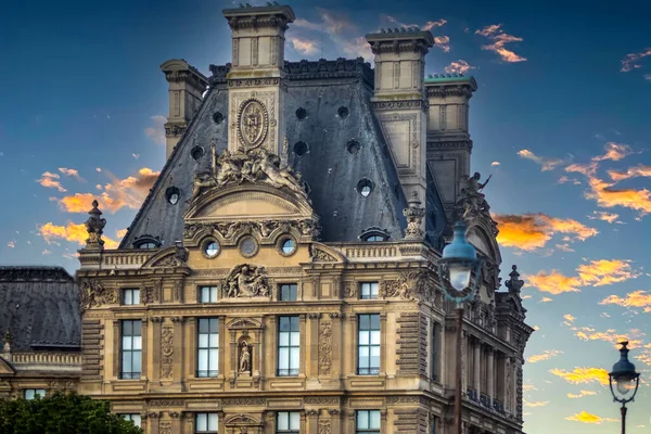 Beautiful house in Paris (France) these houses with so many ornaments and monuments are located next to the Seine river in Paris, and creates a nice contrast with a beautiful orange sky.