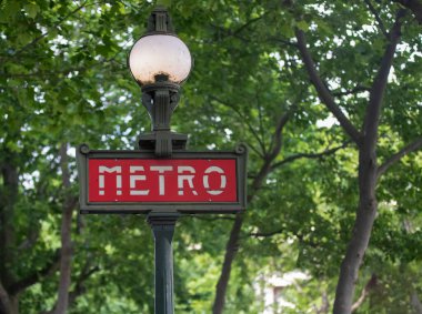 Metal poster lamppost of the metro sign of the French city of Paris, this means of transport runs throughout the city along the Seine River, this beautiful poster is located near the Place of Concord.