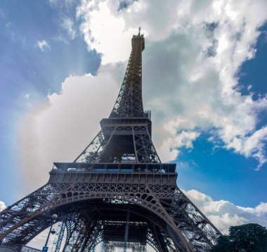 Eiffel Tower seen from its base next to the Seine River in Paris, this place is visited by many travelers and tourists and it is the mythical scenery and background of France.