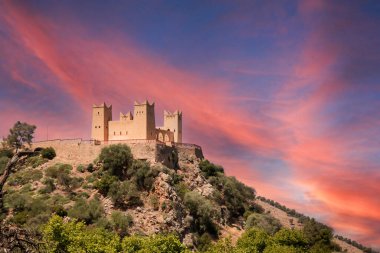Imposing Kasbah of Beni Mellal which is a Berber castle and historical monument in the city of Beni Mellal, Morocco with a beautiful reddish and orange sky. This fortress is in the Tadla plain. clipart