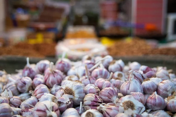 Moroccan street shop with lots of garlic in the city of Beni Mellal, which is located in the center of Morocco in the Middle Atlas, a perfect place to buy spices, nuts and other foods.