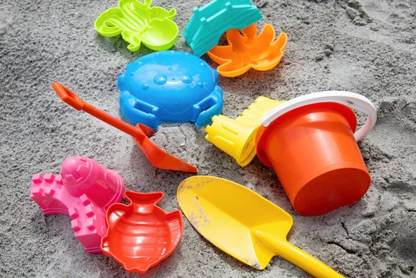 Children toys: bucker, shovel, sand molds lie on the sand. Children\'s beach sand toys. High quality photo