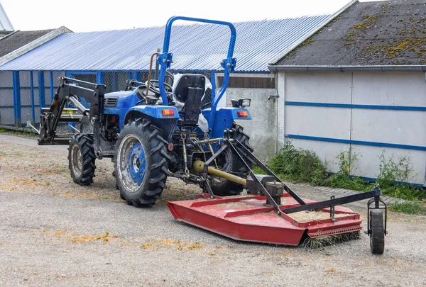 Blue tractor on the farm. Agricultural work and harvesting concept. High quality photo