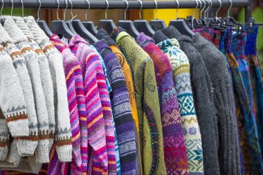 Renkli kazak ve kazaklı elbise askısı.