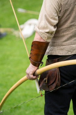 Archery. Archer exercise with the bow, close up photo. Sport, recreation concept