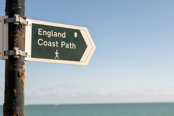 close up england coast track sign on a kentish shingle beach, copy space