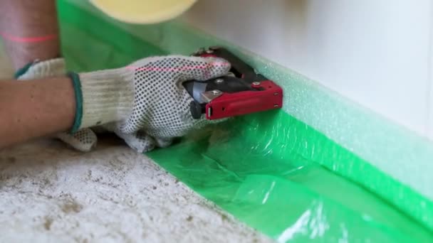 Worker Uses Stapler Attach Damper Tape Wall — Stock Video