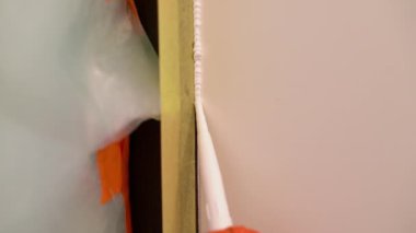 Worker Fills Door And Wall Connection With Acrylic Sealant