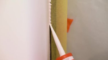 Worker Fills Door And Wall Connection With Acrylic Sealant
