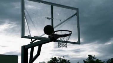 Silhouette Hands Throw The Ball Into The Basketball Hoop, Slow Motion