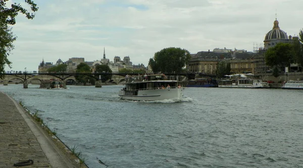 France, Paris, Quai Francois Mitterrand, view of the Seine, bridge of the Arts and a pleasure boat