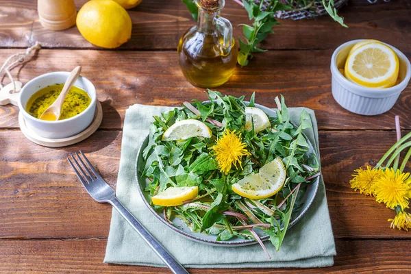 Dandelion salad with dip made with olive oil, lemon juice and spices on brown wooden table. Top view — Fotografie, imagine de stoc