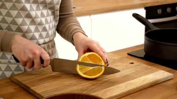 Girl Slices Orange Kitchen Knife — Stok video