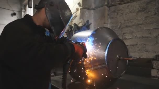 Travailleur dans la construction métallique de soudure de masque de protection à l'usine de travail des métaux. Soudeur faisant joint entre deux détails en acier à la production industrielle. Homme soude des parties du détail métallique ensemble — Video