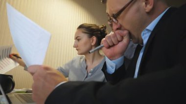 Profesyonel yöneticiler takım toplantısında satış sonuçlarıyla birlikte çizelgeleri inceliyor. Genç meslektaşlarım masada oturan gelir grafiklerini analiz ediyorlar. İş arkadaşları içeriden mali raporları kontrol ediyor. Düşük görünüm