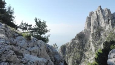 Aerial shot of beautiful landscape with big rocky hills. Drone flying above mountain massif and scenic valley. Nature or travel concept.