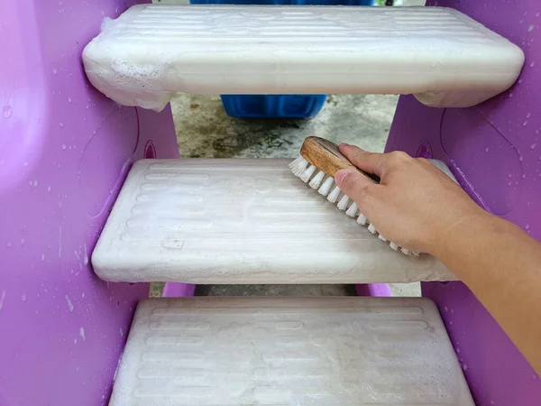 scrubbing brush cleaning on the stairs of children\'s toys.
