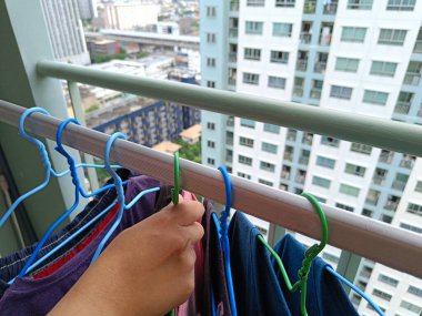 Asian housewives drying clothes on the balcony of a condo or apartment