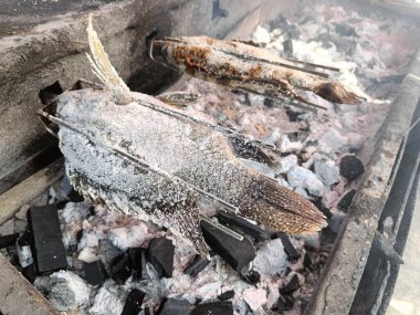 Grilled fish on charcoal grill